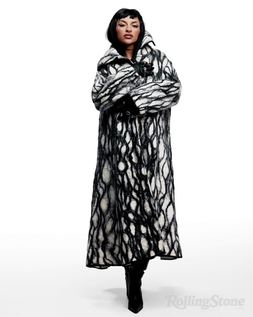 Cazzu posing pregnant for Rolling Stone en Espanol. Fashion credits include: Maxi tapado de pelo, Atelier Pucheta; Top de seda, Baldesari; Jeans con piedras, Kosiuko.; Sandalias, Rick Owens; Guantes de vinilo, Shvnga.; Anillo de plata, Limido.
